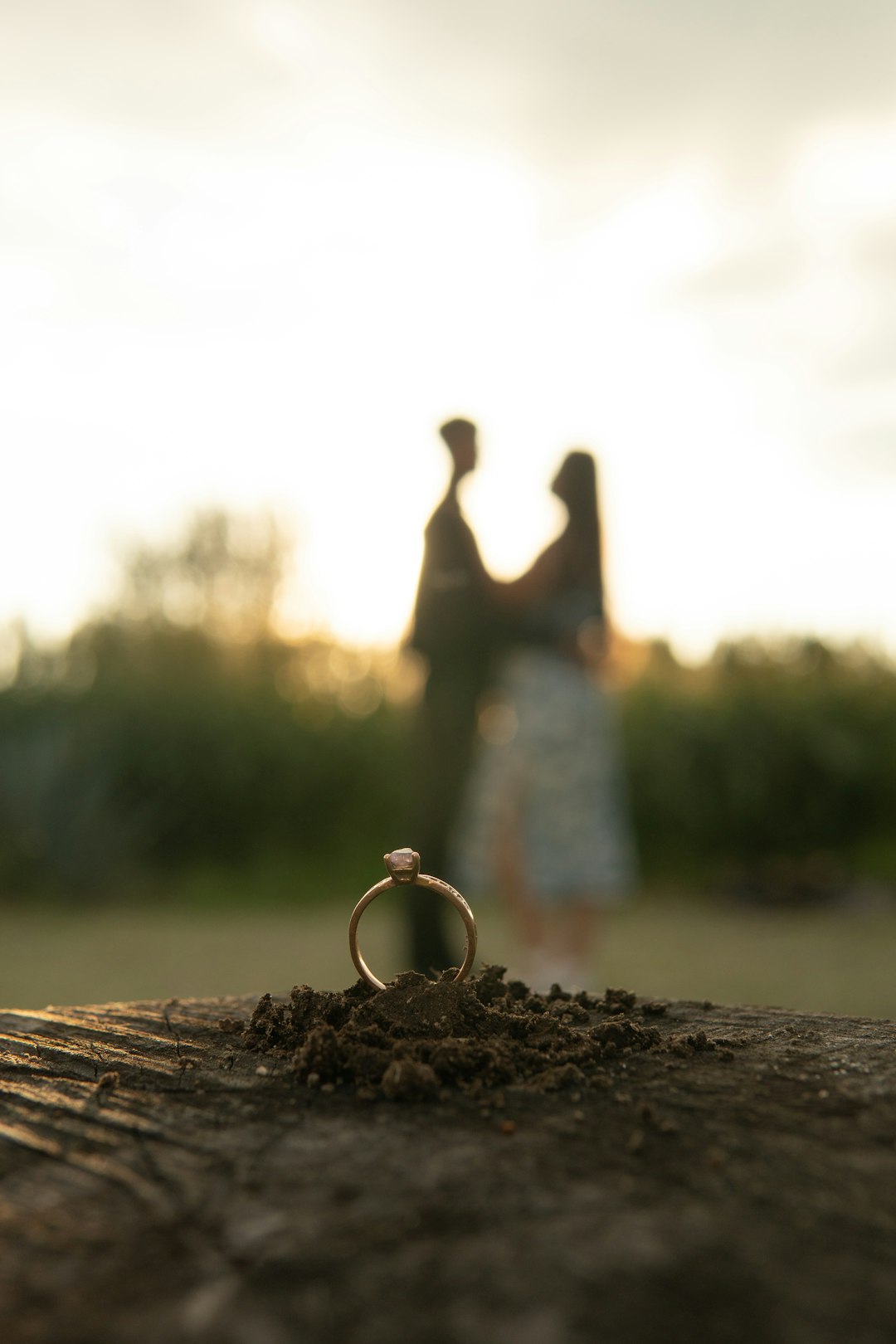 a-couple-standing-next-to-each-other-near-a-ring-mhm0usljay8